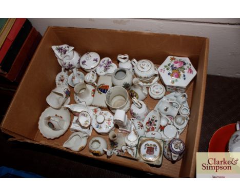 A box of various china to include W.H. Goss crested china, Hammersley, various miniature porcelain tea sets etc. 