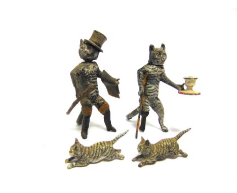 FOUR COLD PAINTED WHITE METAL CATS  late 19th / early 20th century, including one standing with a wooden peg leg and crutch a