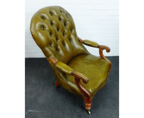 Green leather / vinyl upholstered button back open armchair, with carved arm rests and turned supports, terminating on brass 