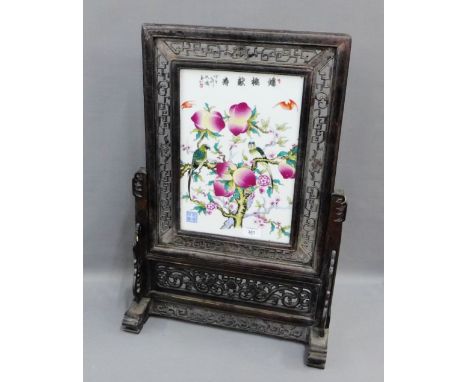 Chinese porcelain fruit painted porcelain plaque table stand, contained within an open fret work ebonised wooden frame and st