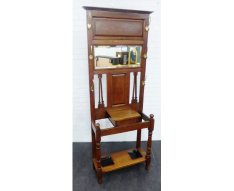 Early 20th century oak hall stand, with mirrored back, lift up glove box, two stick stands with drip trays and brass hooks, 1