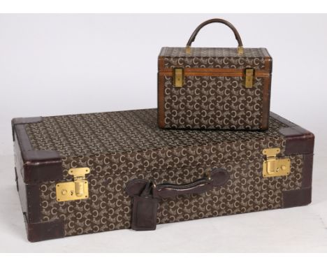 A vintage Celine "C" Macadam pattern, canvas and leather suitcase, together with vanity box. Suitcase measuring 75cm x 42cm x