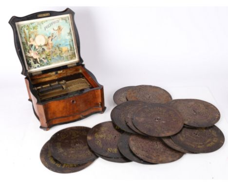 A Victorian Polyphon housed in a walnut case with ivory inlay. Together with a collection of 22 Polyphon metal discs to inclu