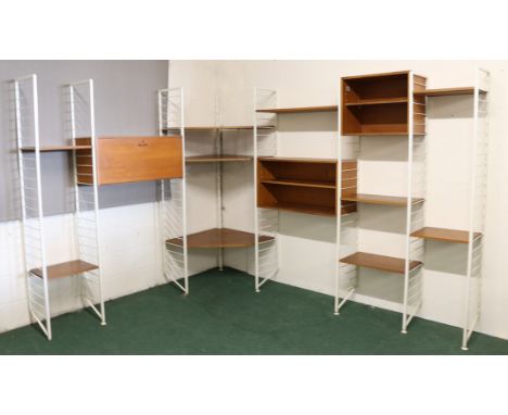 A mid 20th Century teak Ladderax corner modular system on white steel supports, to include various cabinets and shelves. With