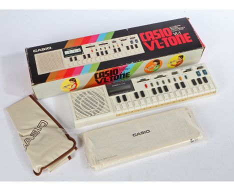 Casio VL-1 VL-TONE electronic musical instrument &amp; calculator with original box and packaging.
