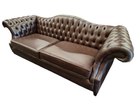 LARGE BROWN LEATHER BUTTON BACK SETTEE AS PART OF THE INTERIOR DESIGN WORK BY JEMIMA EASTWOOD AND FROM THE FORMER HOME OF C S