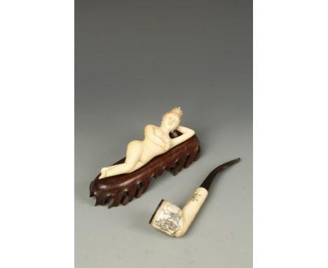 A CHINESE IVORY RECUMBENT 'BEAUTY' AND A PIPE, late Qing/early Republic, 6" and 7" long (2)