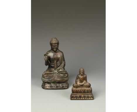 TWO BRONZE SEATED BUDDHAS, the larger Japanese example with one hand raised, 7" high, 19th century (2)