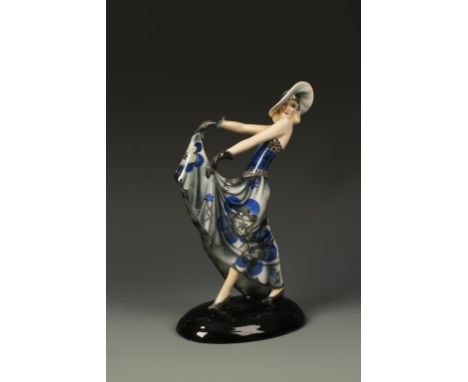 GOLDSCHEIDER: AN EARTHENWARE FIGURE OF A DANCING LADY wearing a hat, painted in blues with flowers, modelled by Stephan Dakon