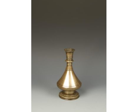 AN INSCRIBED BRASS FLASK, possibly North African, with a faceted body, circa 17th/18thC, 8.5" high