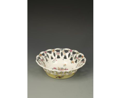 A WORCESTER PORCELAIN ROUND BASKET, the interior polychrome painted with flowers, the exterior applied with flowerheads on ye