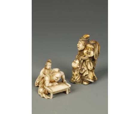 TWO JAPANESE IVORY NETSUKE, one of a woman massaging a man's back, signed, Meiji, 1.5" long; the other of a performer with a 