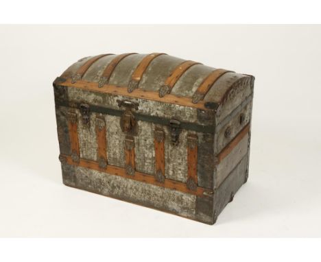 A DOME-TOP TRAVELLING TRUNK with metal fittings, 35" wide