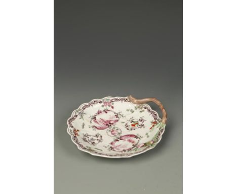 A WORCESTER PORCELAIN 'BLIND EARL' DISH, with a moulded rosebud and stork handle, painted in puce with European buildings in 