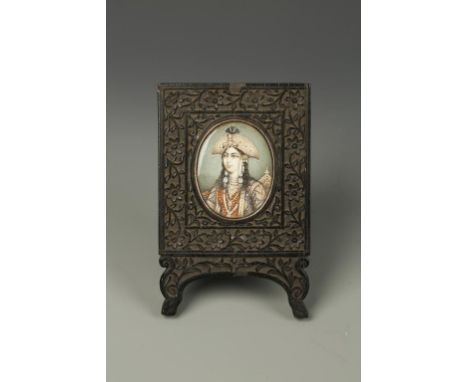 AN INDIAN PORTRAIT MINIATURE OF MUNTAZ MAHAL, 2.5" x 2", in a carved wooden frame