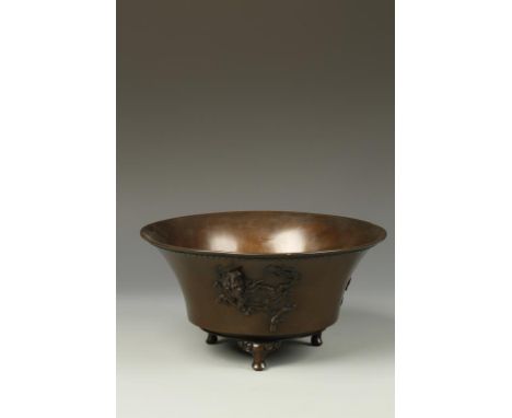 A JAPANESE BRONZE FLARED BOWL decorated in relief with a kirin and ho ho bird, signed Shokaken, Meiji, 10" dia.