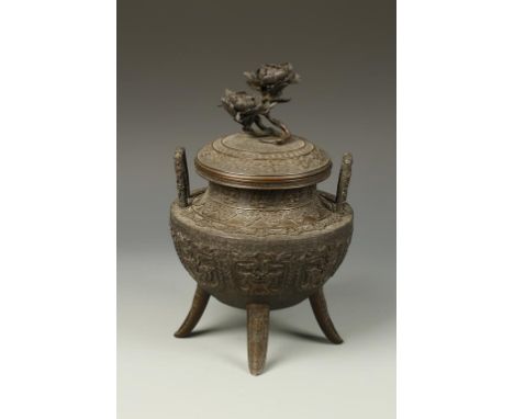 A JAPANESE BRONZE TRIPOD KORO with archaistic relief decoration and a flower finial, signed "Ichijoken Joun", Meiji, 12" high