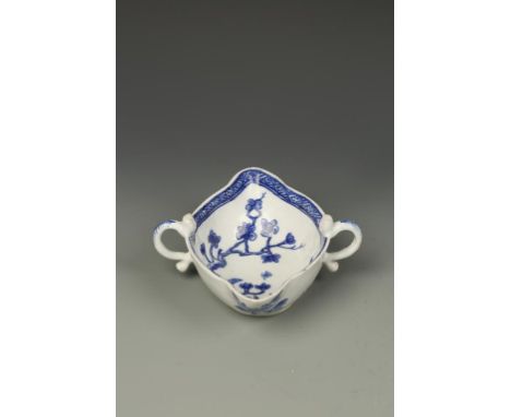 A BOW BLUE AND WHITE PORCELAIN SAUCE BOAT, double lipped with two handles, painted with a bird on a prunus branch within a di