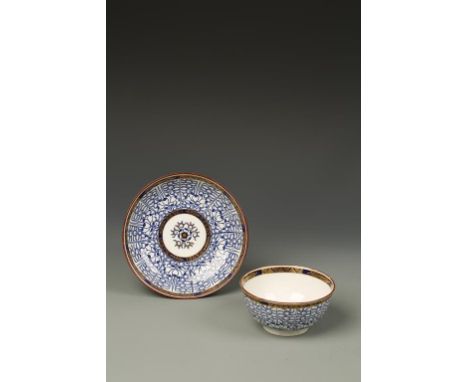 A FLIGHT WORCESTER LARGE BLUE AND WHITE PORCELAIN TEA BOWL AND SAUCER, 'Royal Lily' pattern, within blue and gilt borders and