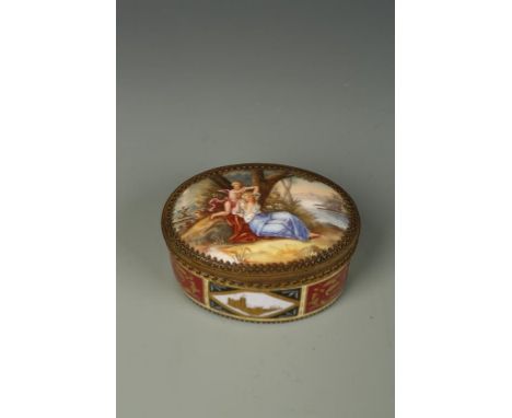 A VIENNA STYLE PORCELAIN TABLE SNUFF BOX, oval with gilt metal mounts, and decorated with painted classical figures and putti