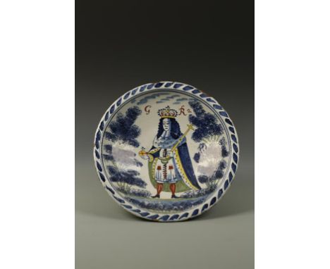 A DELFT BLUE-DASH ROYAL PORTRAIT CHARGER OF GEORGE II, painted in colours with the crowned King in coronation robes, 'GR2' ab