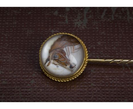 A Victorian Essex intaglio rock crystal stick pin, with circular panel with the head of a horse, on gold pin 