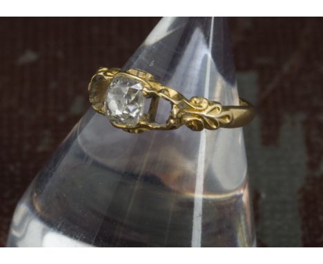 A Victorian diamond ring, the gold mount centred with a 0.62ct old cushion cut stone, lacking two further stones, shank split