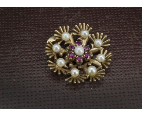 A 1970s 9ct gold pearl and ruby pendant, flower head style mount set with nine pearls and small red stones, 5.5g 
