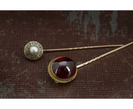 Two Victorian stick pins, one a larger cabochon garnet, the other a cluster with paste and simulated pearl (2) 