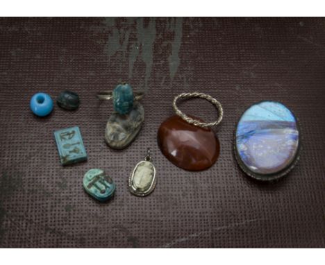 A vintage silver and pottery scarab beetle ring, AF, together with a similar pendant, a hardstone carved scarab beetle, a sil