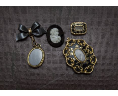 A George IV gold and enamel mourning brooch, togther with another larger pinchbeck example, a locket on bow support, a cameo 