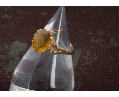 A 1970s gold and citrine solitaire dress ring, orange oval stone in possibly 14ct mount, 3.3g and size N 