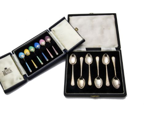 A set of six Art Deco silver and enamel coffee spoons from Garrard & Co, together with a set of six similar period silver cof