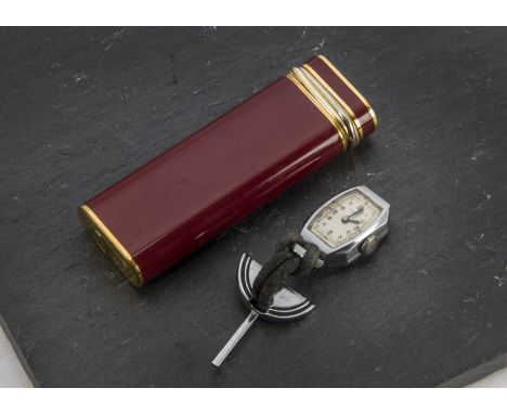 A 1980s red lacquer and gilt cigarette lighter by Cartier, together with a Must de Cartier red watch box C 915 and guarentee 