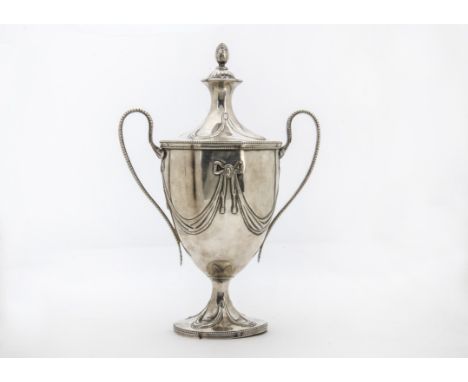 A George III silver trophy cup and cover by William Holmes, the twin ear loop applied handles on tapering body with swags and