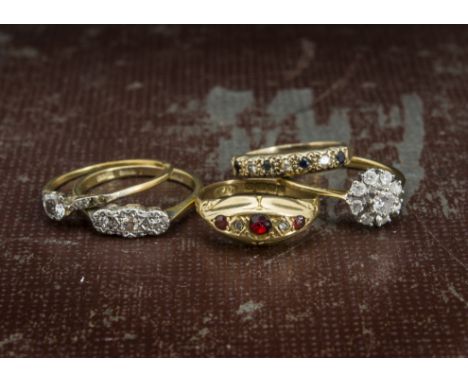 Five gold and gem set rings, including a nice 18ct gold and diamond cluster, an 18ct gold three stone, an 18ct gold ruby and 