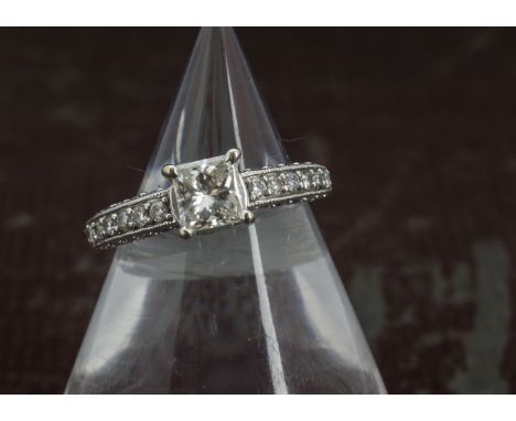 A modern 14ct white gold and diamond engagment ring, having a princess cut stone of approx 1ct in four claw setting on a moun