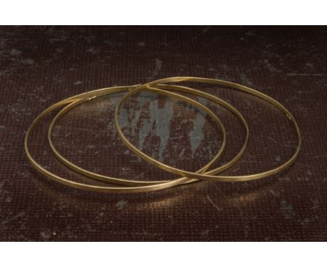 Three vintage Middle Eastern yellow metal bangles, the plain bands each marked 750, 16.8g (3) 