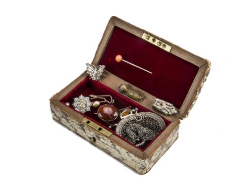An Edwardian period snake skin covered jewellery casket, containing a gold and coral bead stick pin, a carnelian brooch, a go