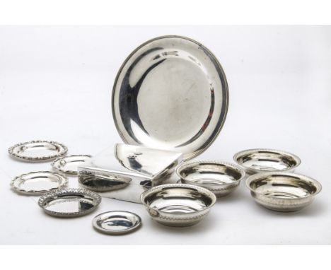 Eleven vintage Middle Eastern silver and white metal items, including a circular tray, a set of four dishes, five small dishe