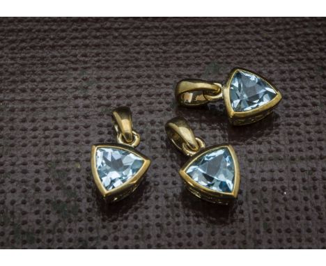 A group of three modern 9ct gold and aqua marine pendant, triangular light blue stone, perfect as a pendant and the other two