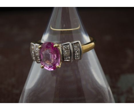 A modern 18ct gold pink sapphire and diamond ring, oval pink stone with two sets of three princess cuts in stepped setting, 3