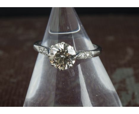 An Art Deco diamond solitaire engagement ring, the 1.3ct transitional brilliant cut in platinum mount have three small diamon