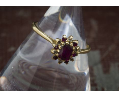 An 18ct gold ruby and diamond cluster ring, 1.9g and size O 