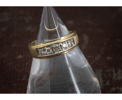 A 1970s 14ct gold and five stone dress ring, graduating brilliant cuts in white gold claws with gold band, 4.2g and size M 