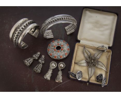 A vintage Chinese silver coral bead and enamel circular brooch, together with two cuff bangles, two pairs of earrings, a flow