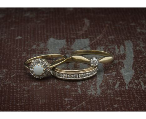 Three 9ct gold and gem set rings, one a solitaire, one with opal, and one a half hoop eternity, 5.6g (3) 