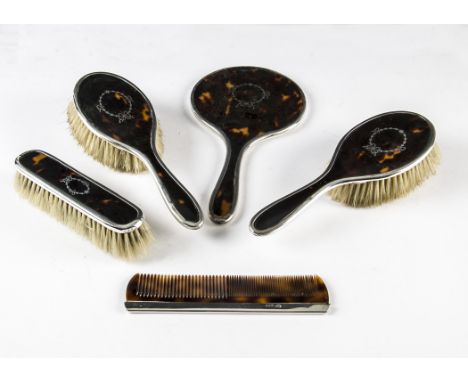 A George V silver and tortoiseshell part dressing table set by Walker & Hall, comprising hand mirror, pair of hair brushes, c