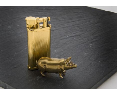 A 1960s Dunhill gilt cigarette lighter, with a brown leather pouch and a brass vesta case in the form of a pig (3) 