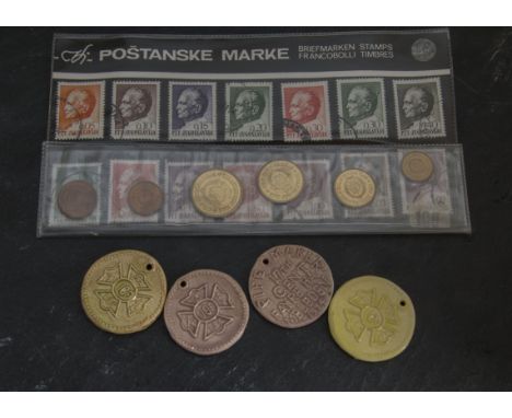 A collection of world coins, large quantity in a tin, together with four ceramic pipe maker tags, and a stamp and coin set fr